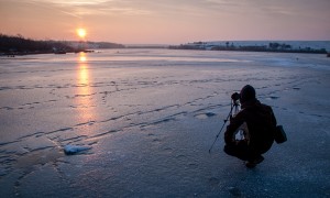 Image of a winter scape, frozen water at sunset