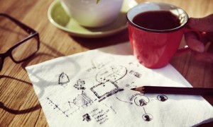 Image of creative thoughts written on a napkin with coffee