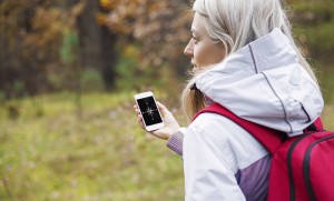 Image of a girl out in nature navigating with smartphone