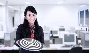 Image of a business woman holding a target