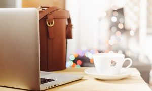 Image of a cup of tea with laptop computer