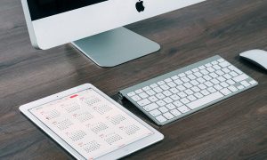 Image of electronic calendar next to desktop computer