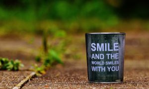 Image of the quote: "Smile and the world smiles with you."