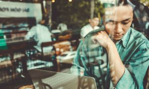 Image of a someone deep in thought at cafe