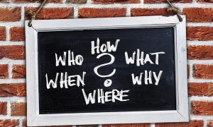 Image of a chalkboard with questions written in chalk