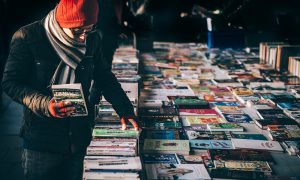 Image of a man looking at books at an outdoor market