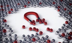 Image of a magnet attracting iron balls to illustrate the power of content marketing