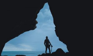 Image of a person in silhouette looking out at the ocean to illustrate the idea of taking a stand on issues