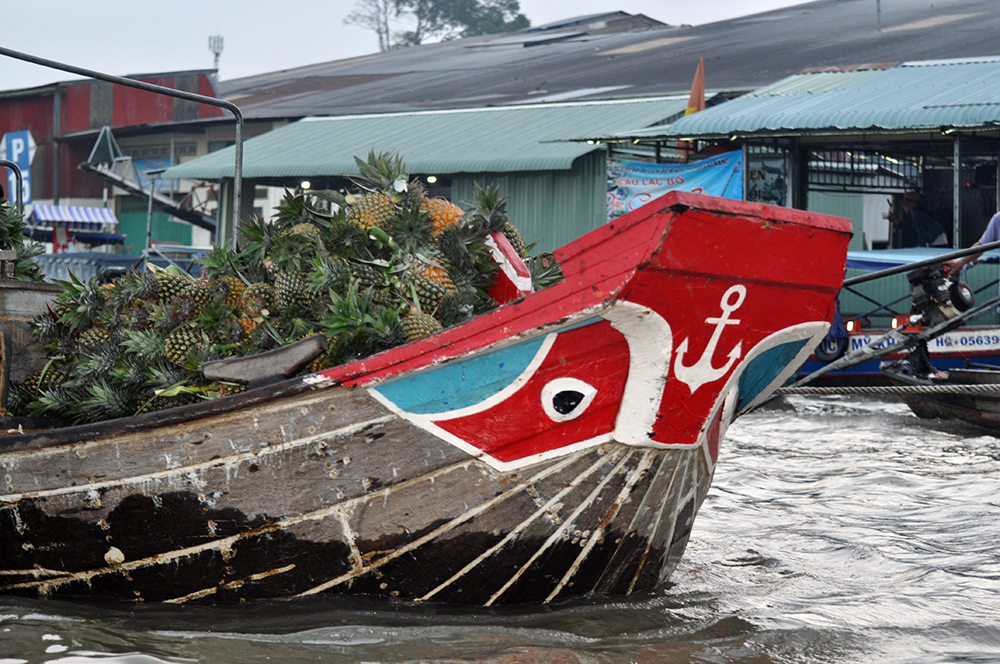 Boat filled with pineapple at floating market in Can Tho, Vietnam